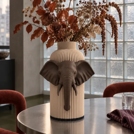 Vaso Elefante marrone e crema della Marrone e Crema Collection, ambientato con rami decorativi e foglie secche.