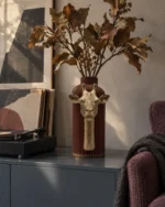 Vaso Giraffa Elegante marrone con decorazione color oro, ambientato con una composizione di rami secchi.