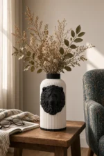 Vaso Leone bianco e nero della Black and White Collection, ambientato con rami decorativi e foglie secche.